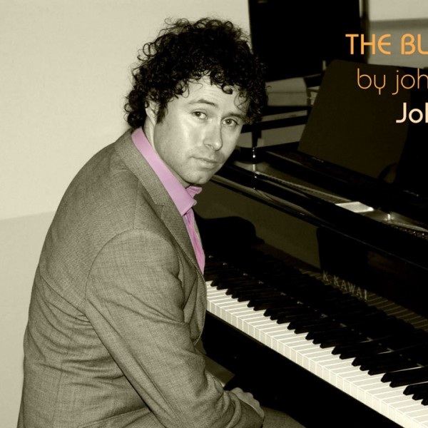 John Manners seated at a piano